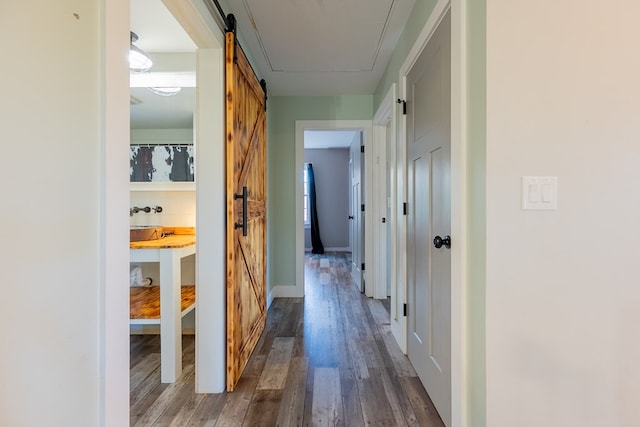 hall with dark hardwood / wood-style flooring and a barn door