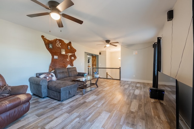 living room with ceiling fan and light wood-type flooring