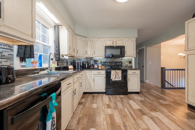 kitchen with sink, backsplash, light hardwood / wood-style floors, and black appliances