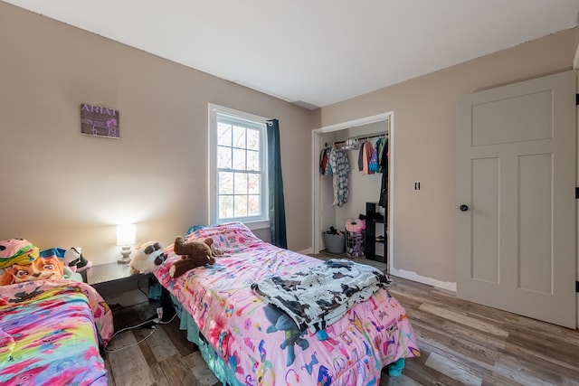 bedroom with wood-type flooring and a closet