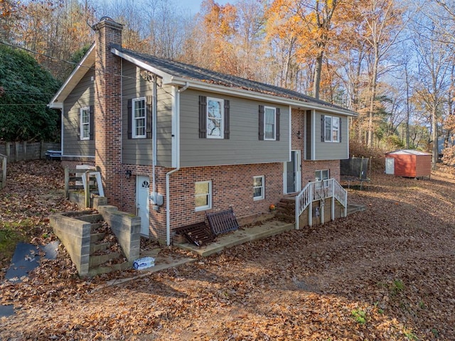 view of front of property with a storage shed