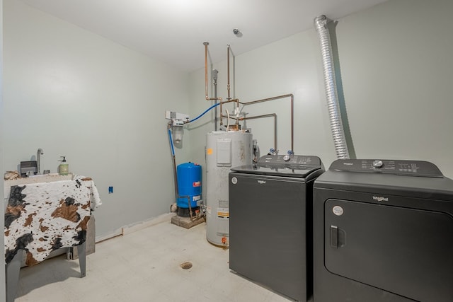 washroom with water heater and washing machine and clothes dryer