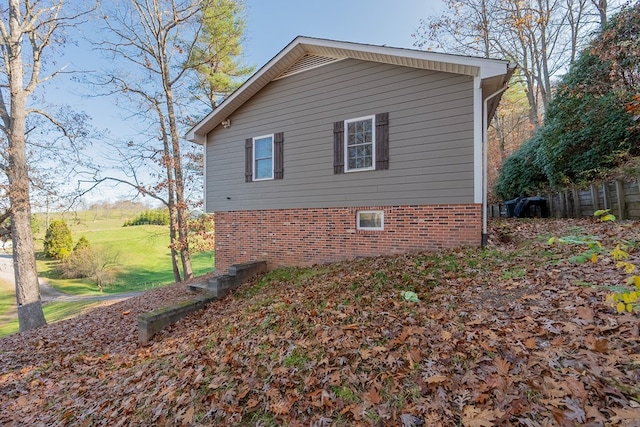 view of side of property with a lawn