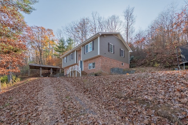 view of home's exterior with a carport and a trampoline