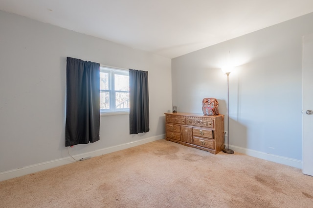 carpeted bedroom with vaulted ceiling