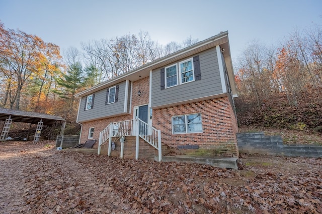 split foyer home featuring a carport