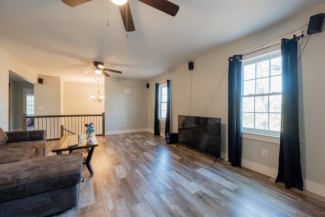 living room featuring a notable chandelier, wood-type flooring, and a wealth of natural light