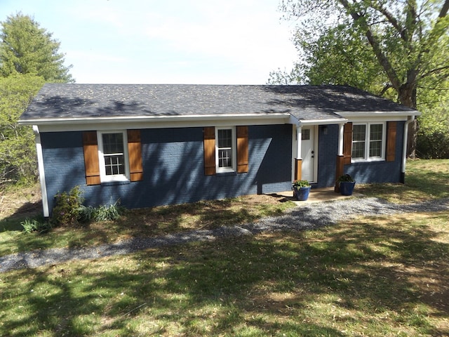 view of front of home with brick siding and a front yard