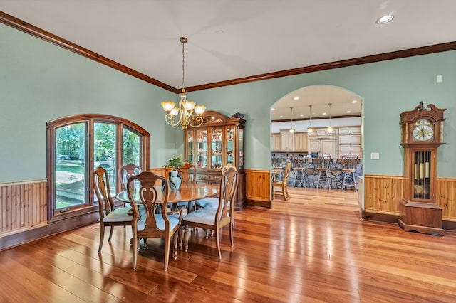 18549 Landridge Way, Abingdon, VA 24211 - dining space with a wainscoted wall, wood walls, arched walkways, light wood-style floors, and a chandelier