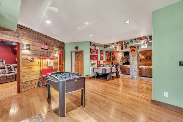 18549 Landridge Way, Abingdon, VA 24211 - game room with wooden walls, wood finished floors, a fireplace, recessed lighting, and an accent wall