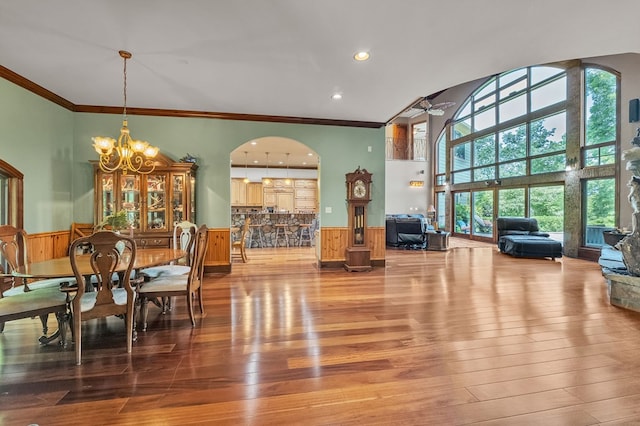18549 Landridge Way, Abingdon, VA 24211 - dining space with wainscoting, ornamental molding, a chandelier, wood finished floors, and arched walkways