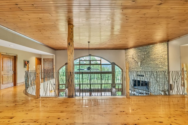 18549 Landridge Way, Abingdon, VA 24211 - unfurnished living room featuring wood ceiling, ornamental molding, a ceiling fan, wood finished floors, and a stone fireplace
