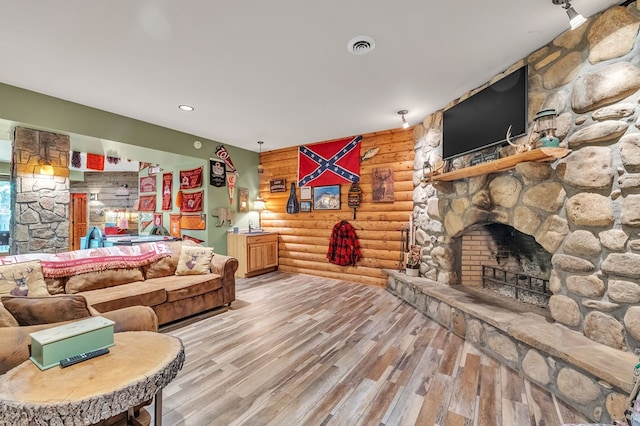 18549 Landridge Way, Abingdon, VA 24211 - living room featuring rustic walls, wood finished floors, and a fireplace