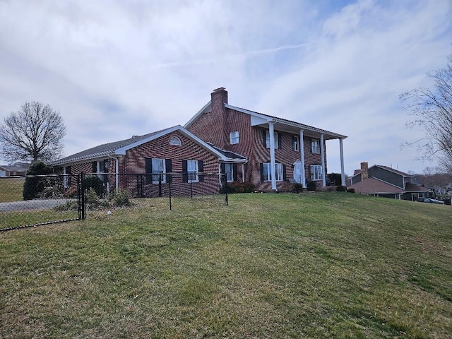 419 Tanglewood Dr, Glade Spring, VA 24340 - greek revival house featuring a chimney, brick siding, a front lawn, and fence