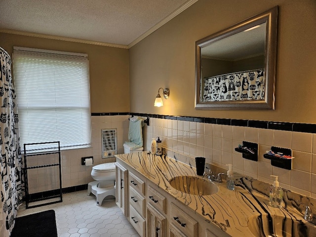 419 Tanglewood Dr, Glade Spring, VA 24340 - full bathroom with tile walls, toilet, vanity, crown molding, and a wainscoted wall
