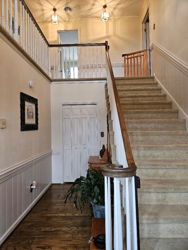 419 Tanglewood Dr, Glade Spring, VA 24340 - stairs featuring visible vents, wood finished floors, wainscoting, and a high ceiling