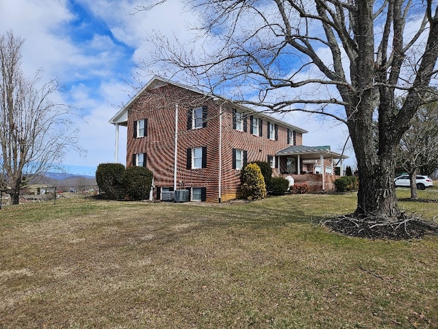 419 Tanglewood Dr, Glade Spring, VA 24340 - view of side of property featuring covered porch, central AC unit, brick siding, and a lawn