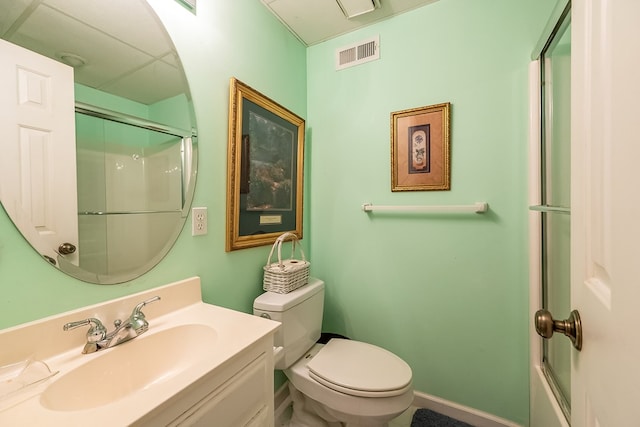 bathroom with a shower with shower door, vanity, toilet, and visible vents