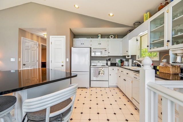 kitchen with vaulted ceiling, white appliances, white cabinetry, and glass insert cabinets