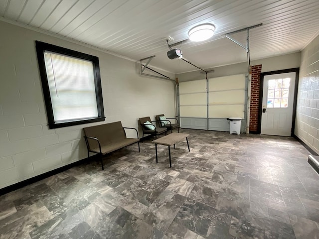 garage with concrete block wall and a garage door opener