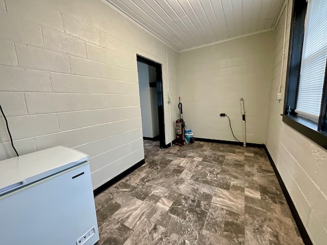 unfurnished room with concrete block wall