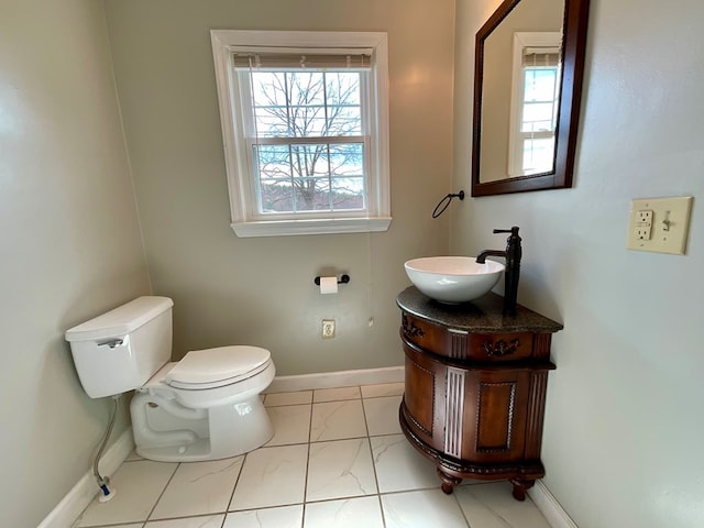bathroom with marble finish floor, baseboards, toilet, and vanity