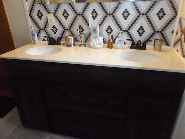 bathroom featuring vanity and backsplash