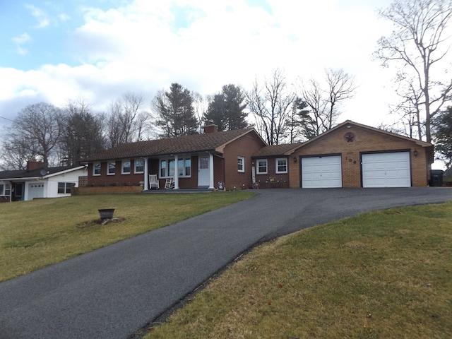 ranch-style home with a garage and a front lawn