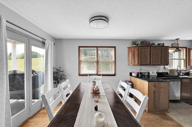 178 Woodside Dr, Chilhowie, VA 24319 - dining area featuring a textured ceiling, healthy amount of natural light, and light wood-style flooring