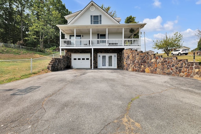 178 Woodside Dr, Chilhowie, VA 24319 - view of front of home featuring french doors, asphalt driveway, a garage, fence, and stone siding