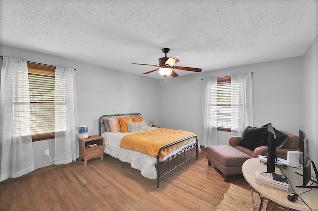 178 Woodside Dr, Chilhowie, VA 24319 - bedroom featuring a textured ceiling, wood finished floors, baseboards, and a ceiling fan