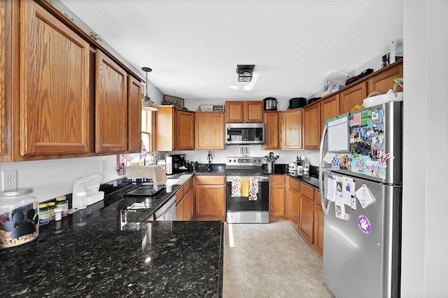 178 Woodside Dr, Chilhowie, VA 24319 - kitchen featuring stainless steel appliances, brown cabinetry, and plenty of natural light