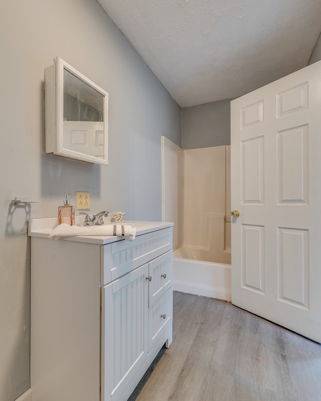 103 Whites Subdivision Rd, Cedar Bluff, VA 24609 - full bathroom with vanity, wood finished floors, and a textured ceiling