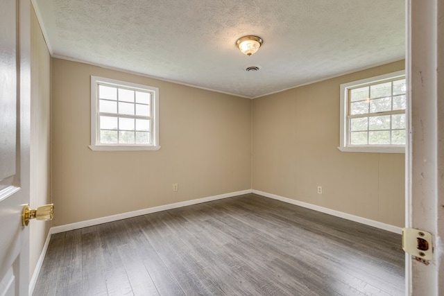 103 Whites Subdivision Rd, Cedar Bluff, VA 24609 - spare room featuring healthy amount of natural light, wood finished floors, baseboards, a textured ceiling, and ornamental molding