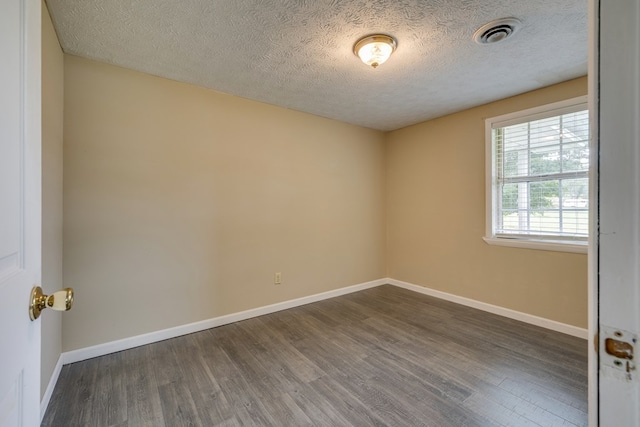 103 Whites Subdivision Rd, Cedar Bluff, VA 24609 - spare room featuring wood finished floors, a textured ceiling, and baseboards
