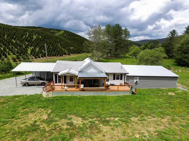 232 Echo Ridge Ln, Elk Creek, VA 24326 - back of property featuring a lawn, a forest view, a carport, and a deck with mountain view