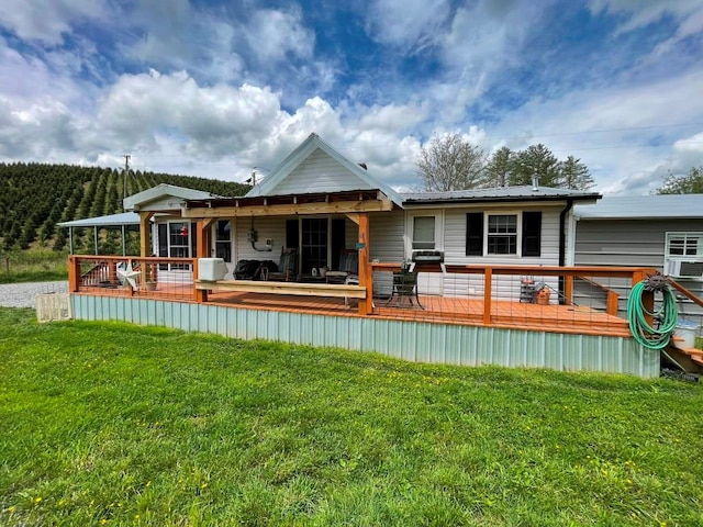 232 Echo Ridge Ln, Elk Creek, VA 24326 - back of property with a lawn, a wooden deck, and metal roof