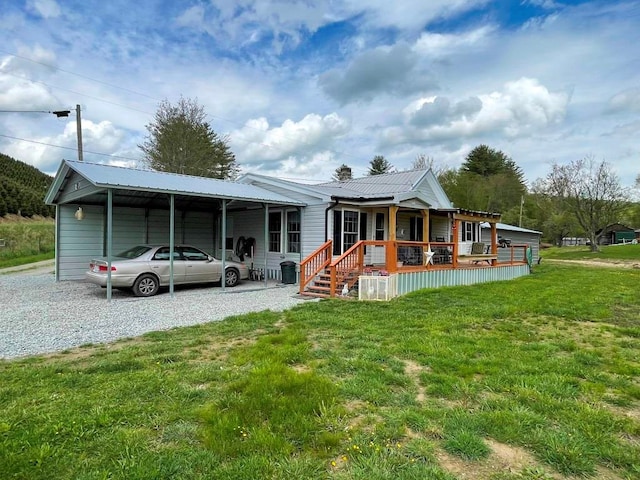 232 Echo Ridge Ln, Elk Creek, VA 24326 - rear view of house with covered porch, a yard, a carport, metal roof, and driveway