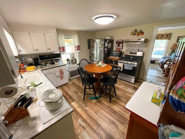 232 Echo Ridge Ln, Elk Creek, VA 24326 - kitchen with appliances with stainless steel finishes, under cabinet range hood, a sink, light wood finished floors, and light countertops