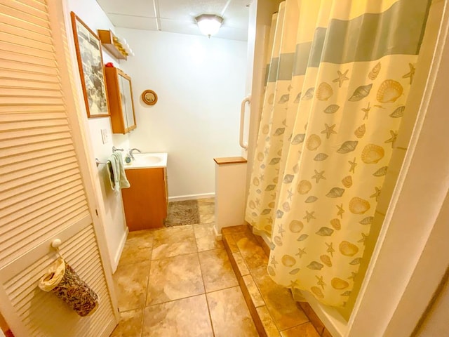 1476 E Blue Grass Trl, Bland, VA 24315 - full bath featuring vanity, tile patterned flooring, a shower with shower curtain, a paneled ceiling, and baseboards
