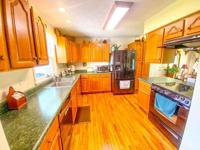 1476 E Blue Grass Trl, Bland, VA 24315 - kitchen featuring black appliances, a sink, under cabinet range hood, light wood-type flooring, and brown cabinets