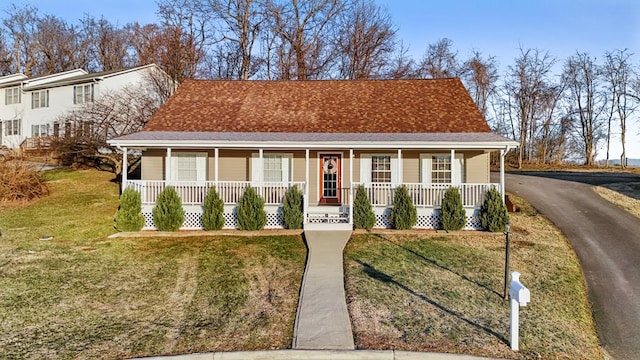 view of front of house featuring covered porch and a front yard