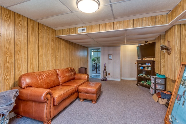 9433 Legend Dr, Glade Spring, VA 24340 - carpeted living area featuring washer and clothes dryer, wood walls, and a paneled ceiling