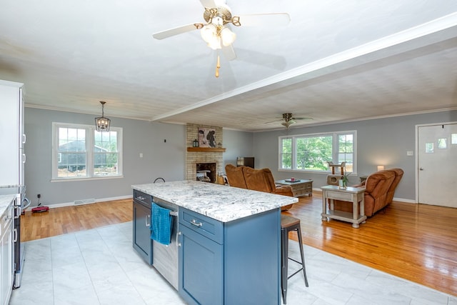 9433 Legend Dr, Glade Spring, VA 24340 - kitchen featuring blue cabinets, ceiling fan, ornamental molding, a kitchen breakfast bar, and open floor plan