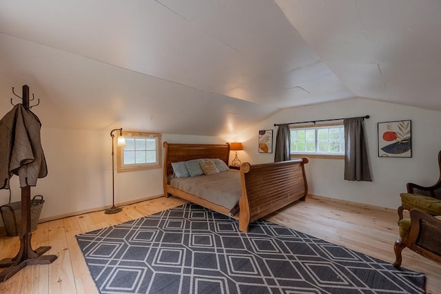 bedroom with hardwood / wood-style floors and vaulted ceiling