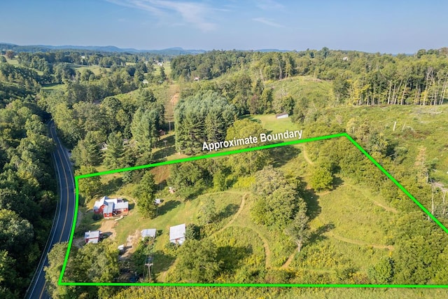 aerial view of property's location with property boundaries highlighted and a heavily wooded area
