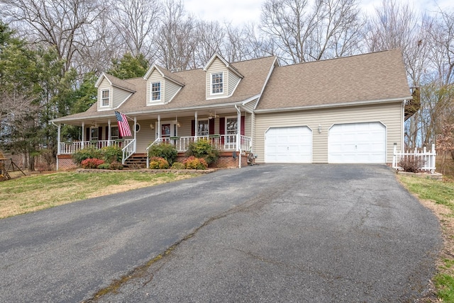 cape cod home featuring a garage, covered porch, driveway, and a shingled roof