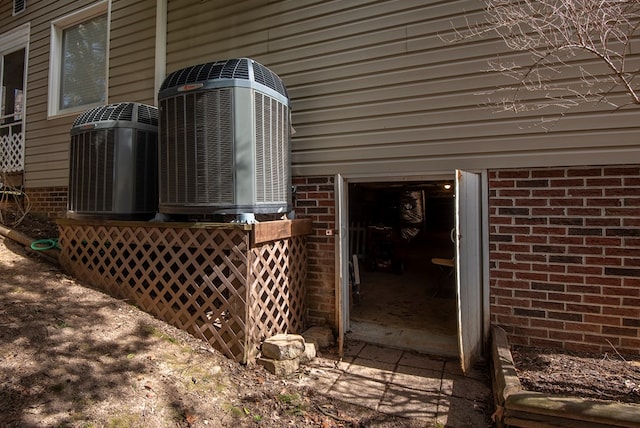 exterior details featuring brick siding and central air condition unit