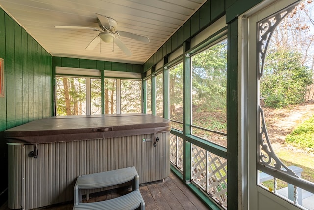 sunroom / solarium with a wealth of natural light, heating unit, and a ceiling fan