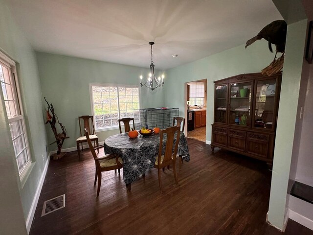 196 Goodwin Rd, Cedar Bluff, VA 24609 - dining room with dark wood-style flooring, a chandelier, and baseboards